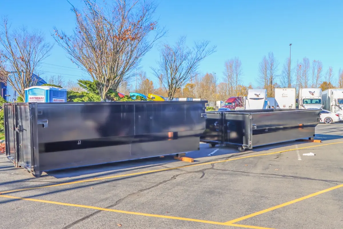Professional dumpster rental service with roll-off container on residential driveway in Fairland